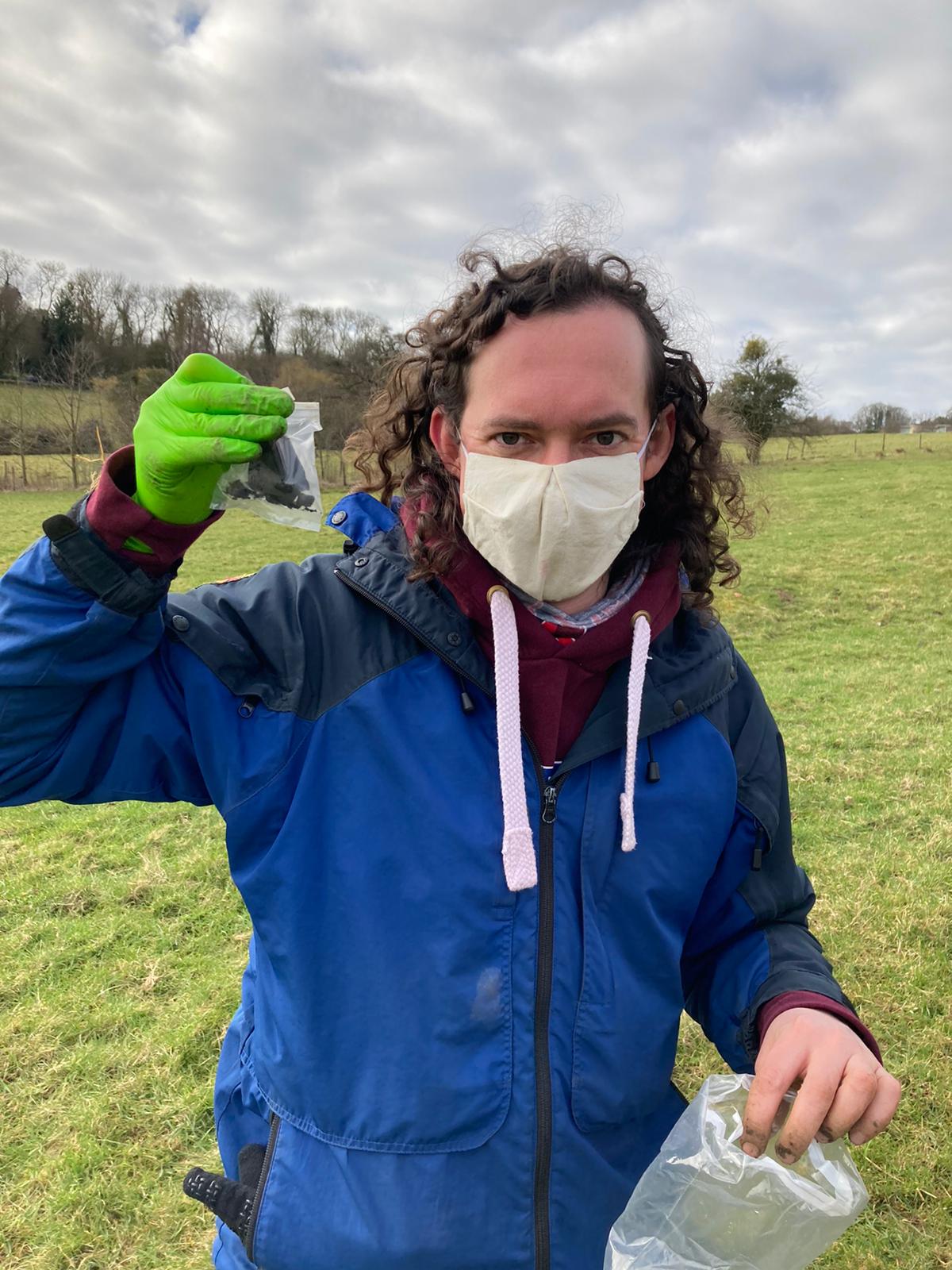 Dr Luke Daly, holding the precious sample, in full covid-ready meteorite searching attire